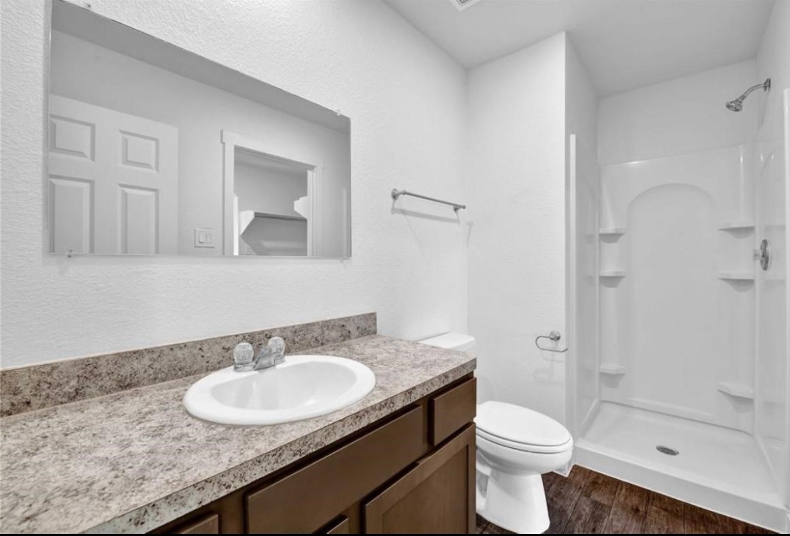 12603 Telge Road, Unit 28C Cypress, TX 77429 - Photo 14 of 25 a bathroom with a granite countertop sink a toilet and shower