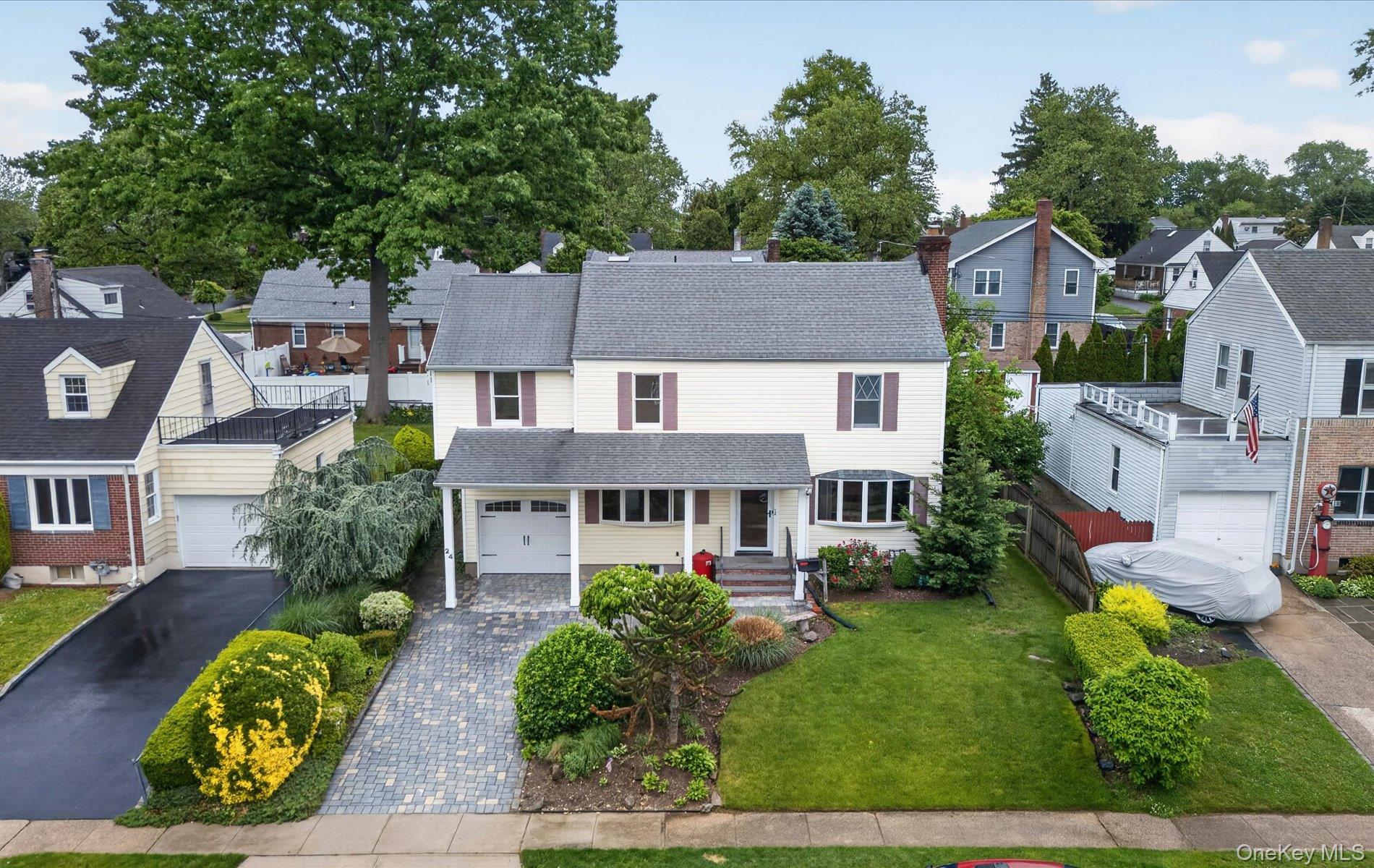 24 Purdue Road Glen Cove, NY 11542 - Photo 4 of 41 a aerial view of a residential apartment building with a yard and potted plants