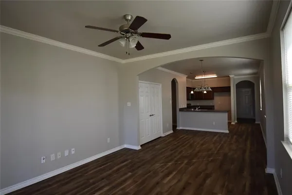 a view of a hallway view with wooden floor and chandelier