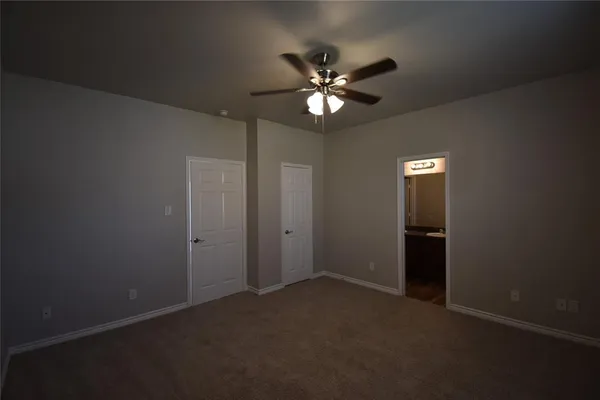 a view of an empty room with a fan