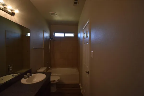 a bathroom with a sink shower and a mirror