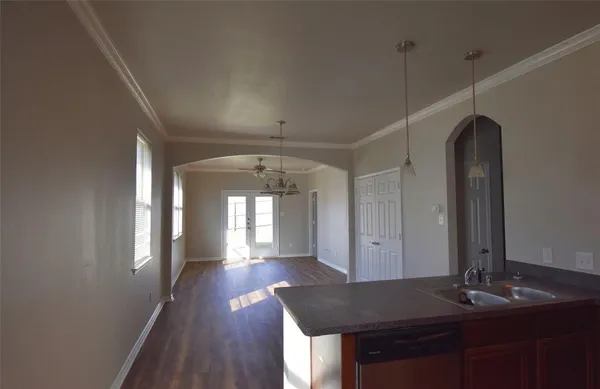 a view of a hallway to a house and wooden floor