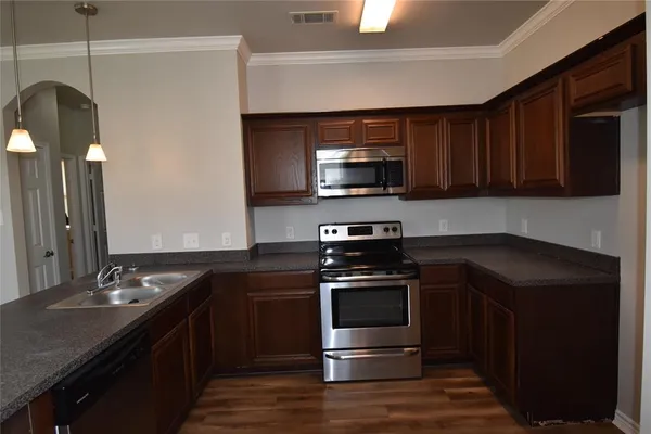 a kitchen with a sink stove and microwave