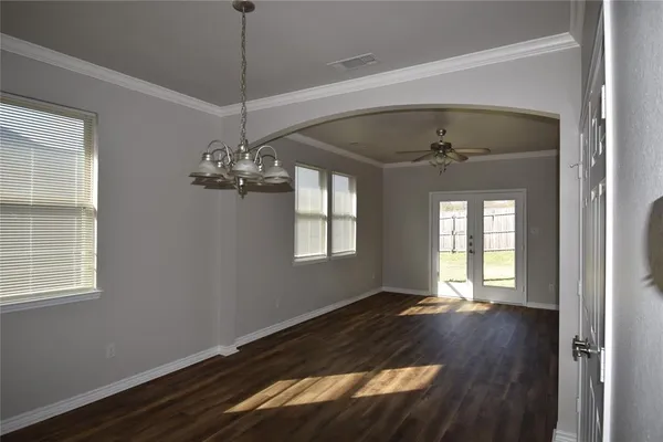 a view of a room with wooden floor and windows
