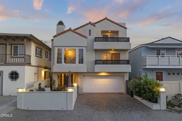 a front view of a house with a yard and a garage