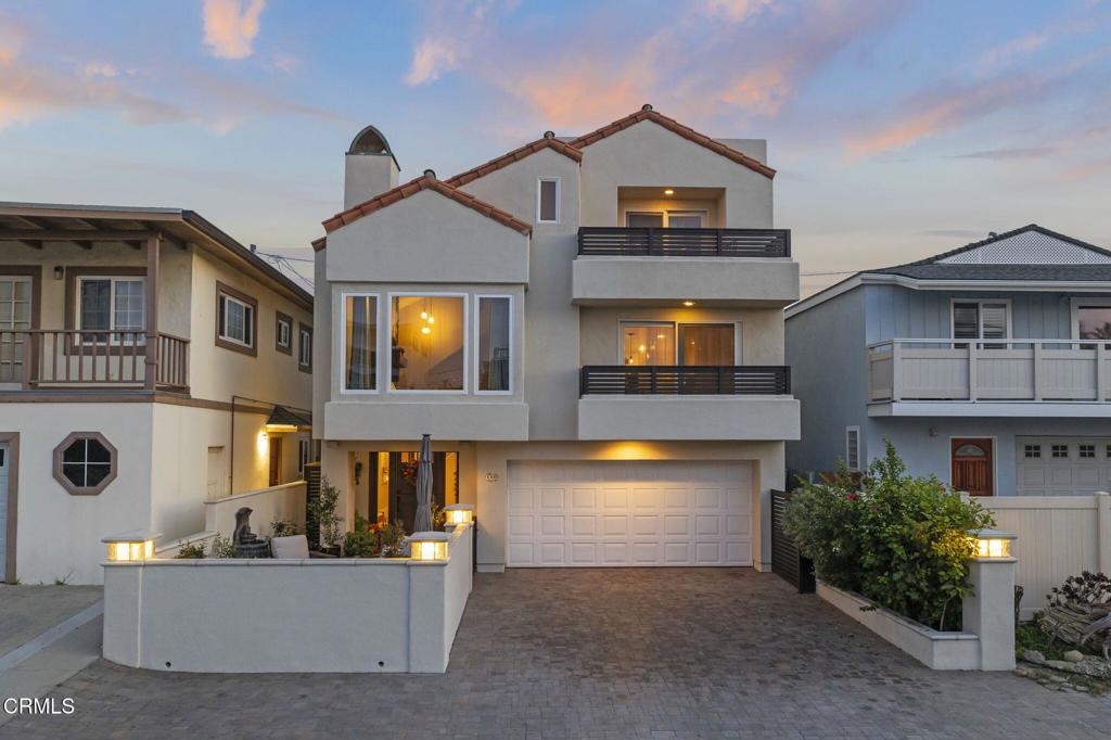 a front view of a house with a yard and a garage