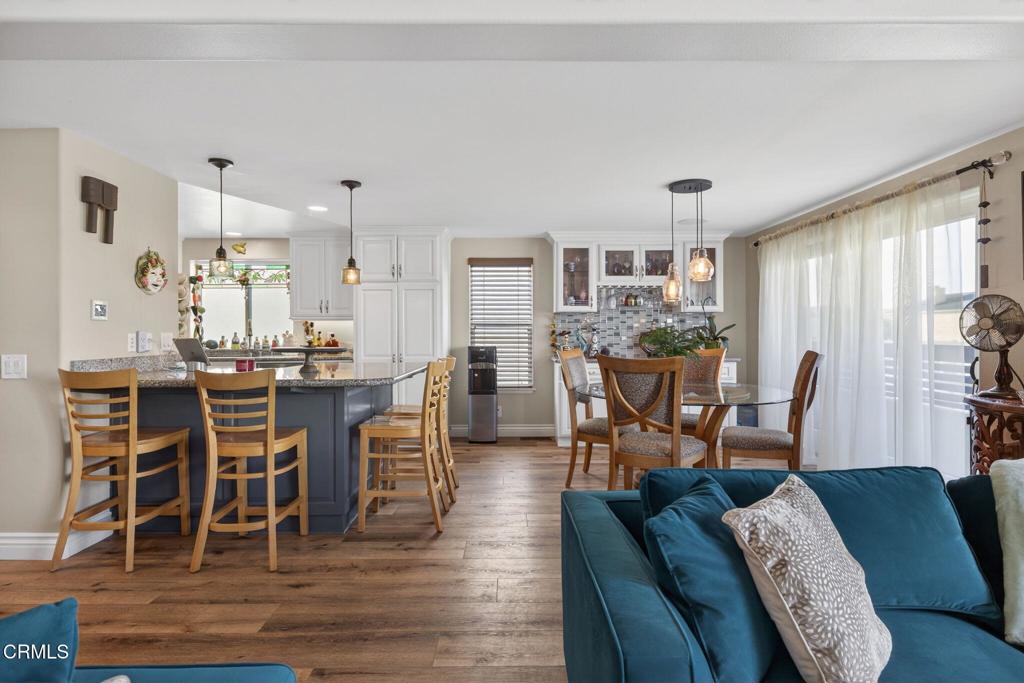 116 Pasadena Avenue Oxnard, CA 93035 - Photo 14 of 52 a dining room with furniture a chandelier and wooden floor