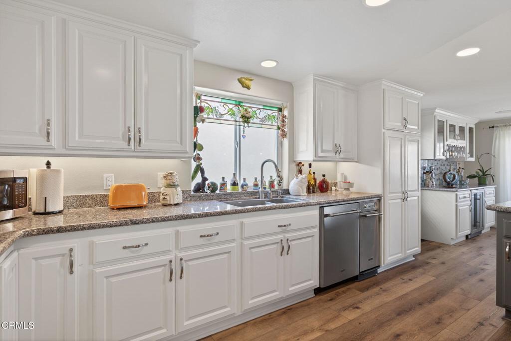 116 Pasadena Avenue Oxnard, CA 93035 - Photo 19 of 52 a kitchen with granite countertop white cabinets and white stainless steel appliances