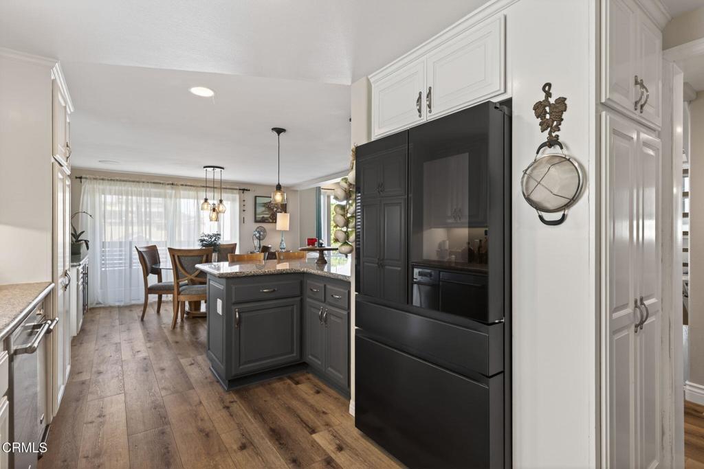 116 Pasadena Avenue Oxnard, CA 93035 - Photo 21 of 52 a kitchen with wooden cabinets and stainless steel appliances