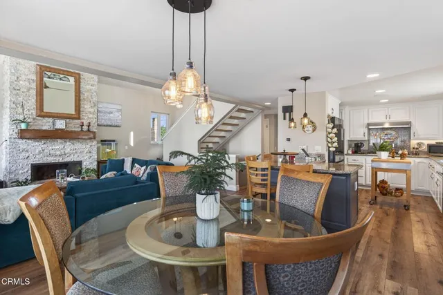 a dining room with furniture a chandelier and wooden floor