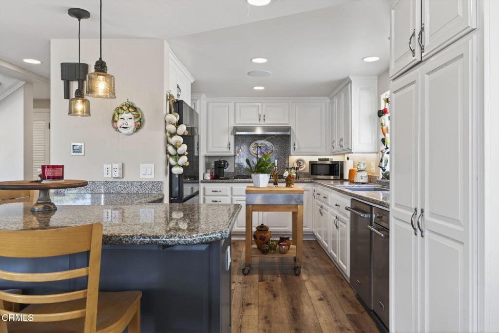 116 Pasadena Avenue Oxnard, CA 93035 - Photo 24 of 52 a kitchen with stainless steel appliances granite countertop sink stove top oven and cabinets