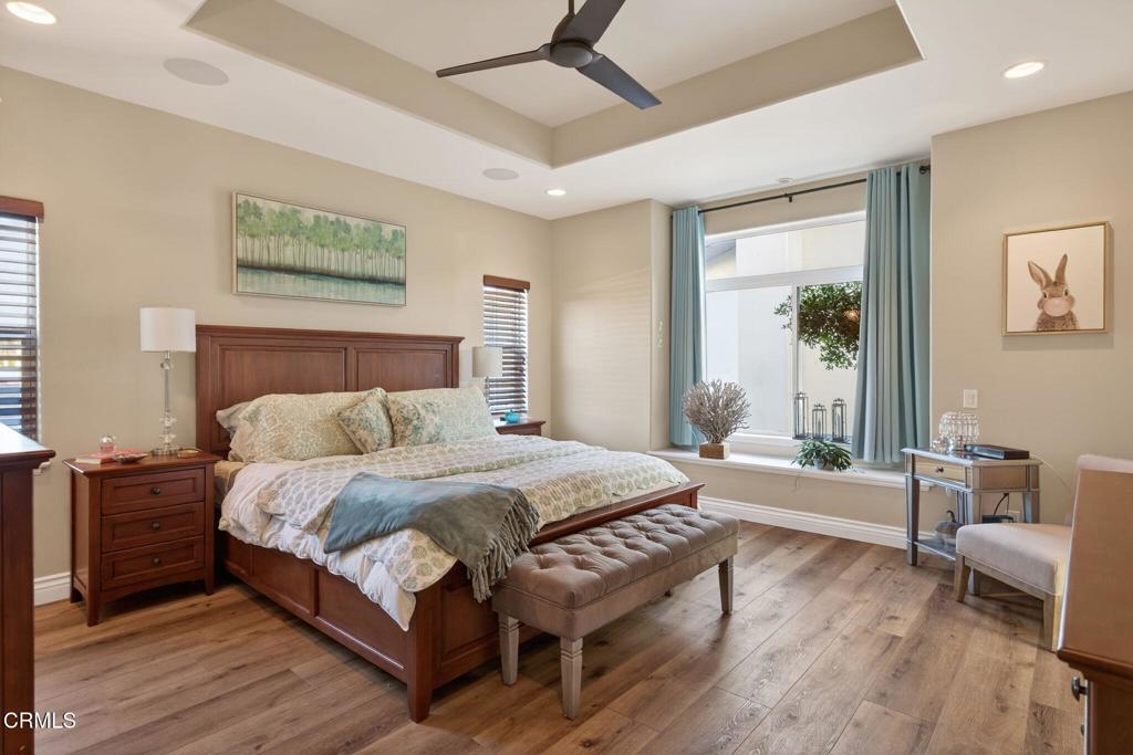 116 Pasadena Avenue Oxnard, CA 93035 - Photo 25 of 52 a bedroom with a bed and a wooden floor