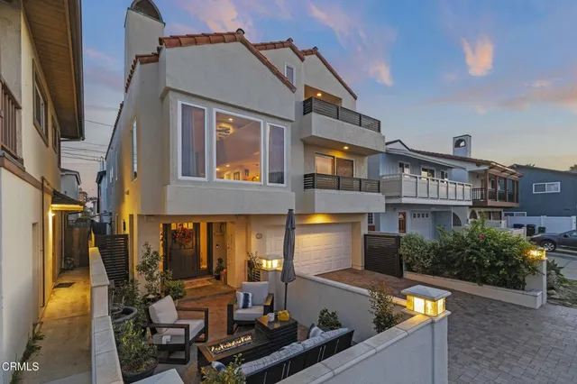 a view of a house with swimming pool and sitting area