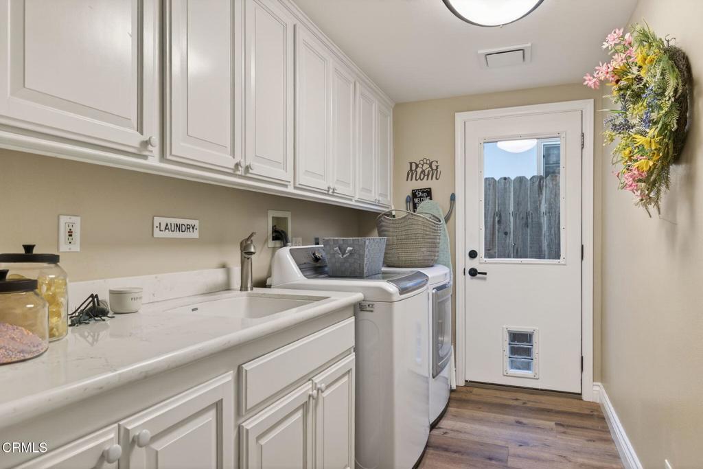116 Pasadena Avenue Oxnard, CA 93035 - Photo 35 of 52 a utility room with stainless steel appliances granite countertop a sink and dishwasher with white cabinets