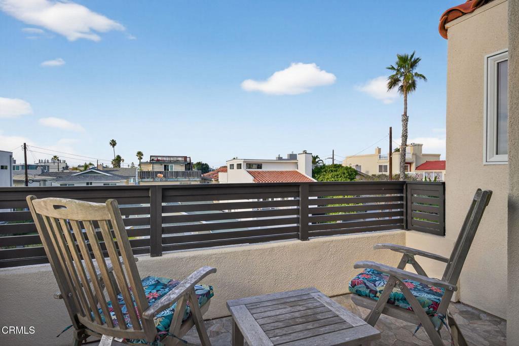 116 Pasadena Avenue Oxnard, CA 93035 - Photo 38 of 52 a view of a balcony with two chairs and a potted plant