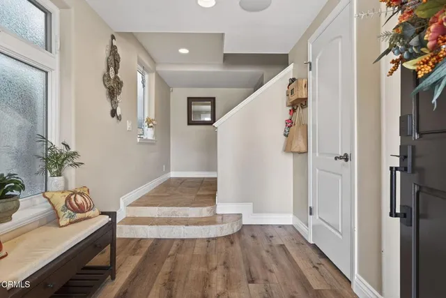 a view of entryway and hall with wooden floor