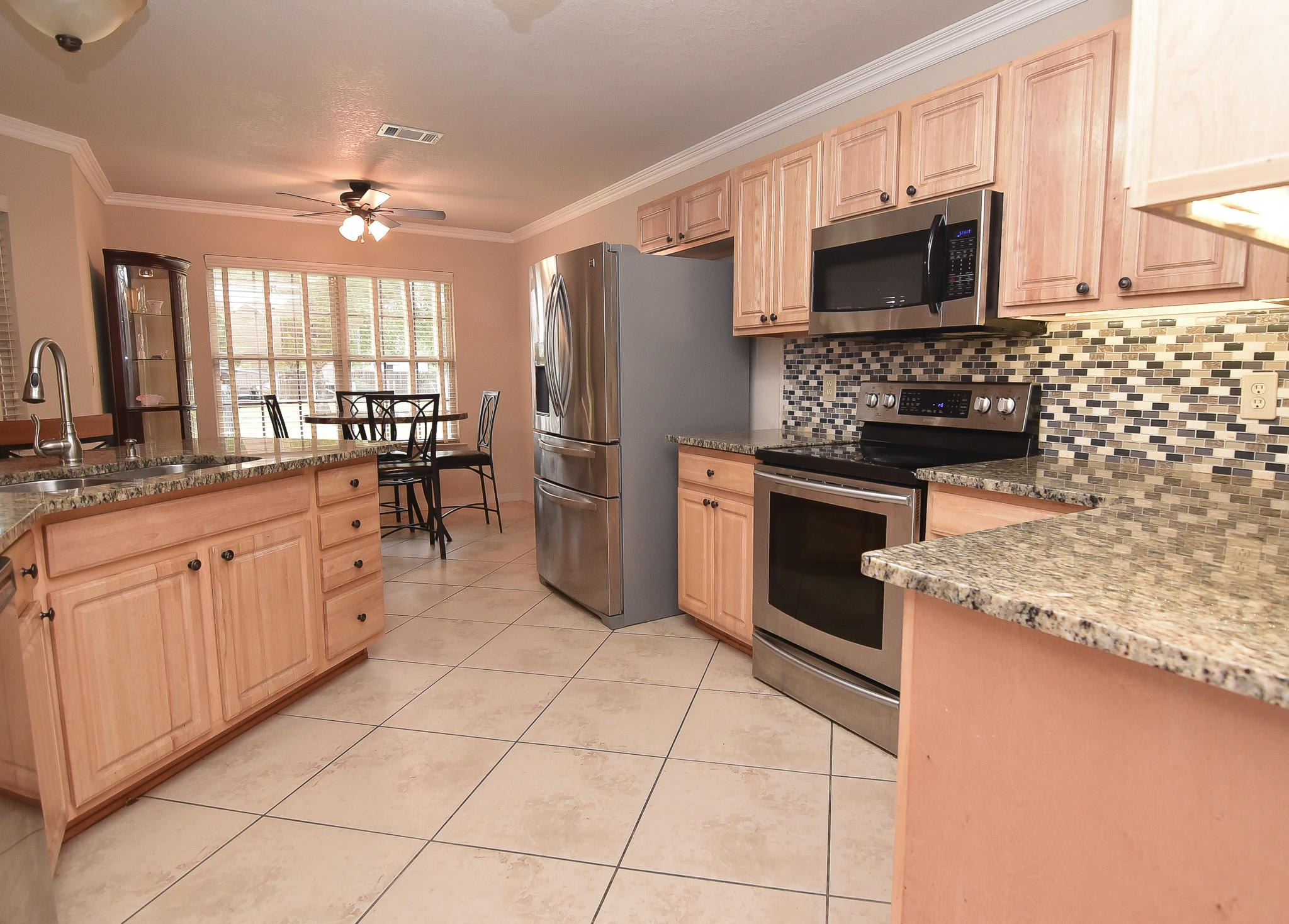 4214 Painter Branch Road Crestview, FL 32539 - Photo 14 of 41 a large kitchen with cabinets stainless steel appliances and a sink