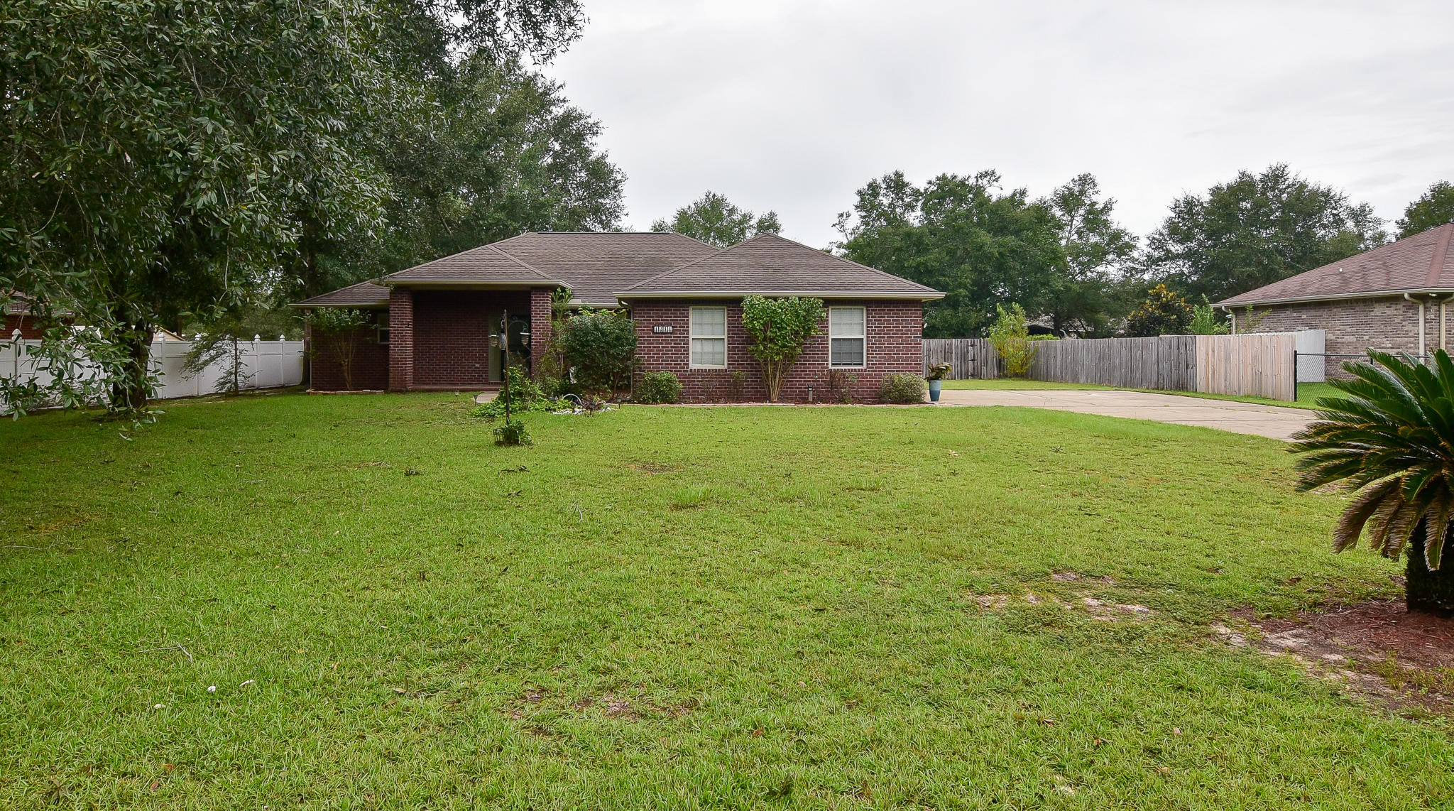 4214 Painter Branch Road Crestview, FL 32539 - Photo 3 of 41 a backyard of a house with table and chairs