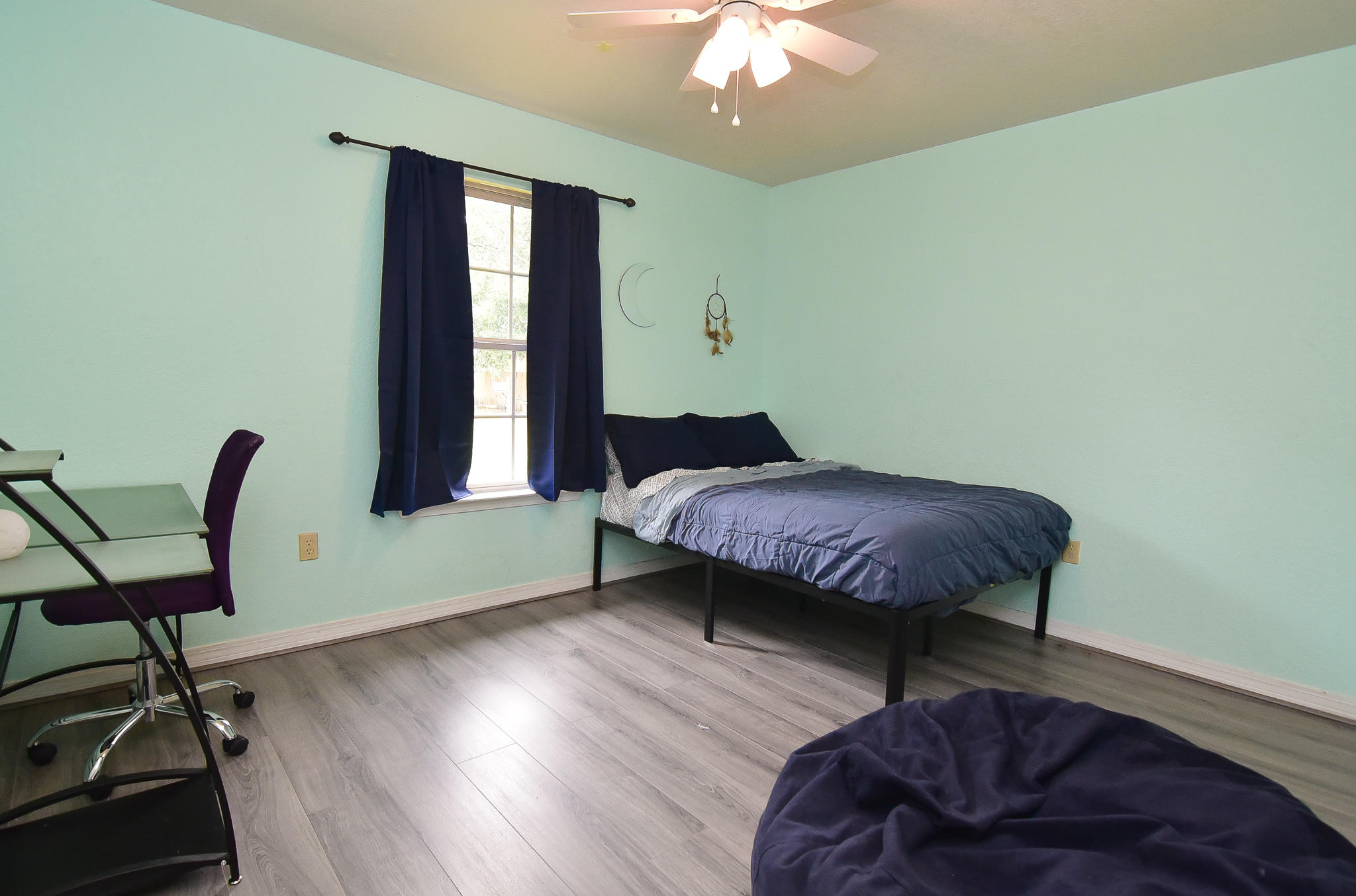 4214 Painter Branch Road Crestview, FL 32539 - Photo 25 of 41 a bedroom with a bed and a chair