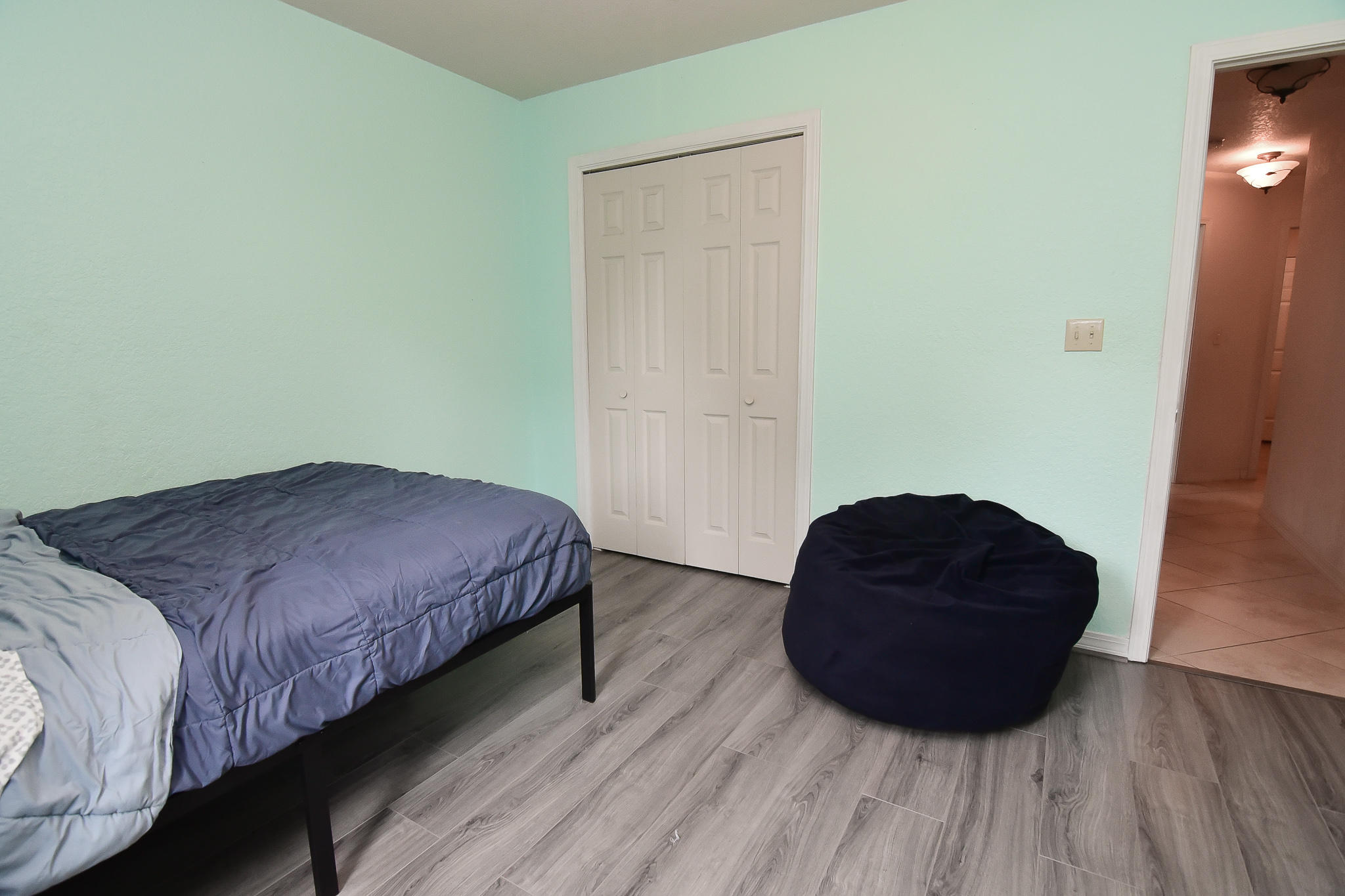 4214 Painter Branch Road Crestview, FL 32539 - Photo 26 of 41 a bedroom with a bed and a chair