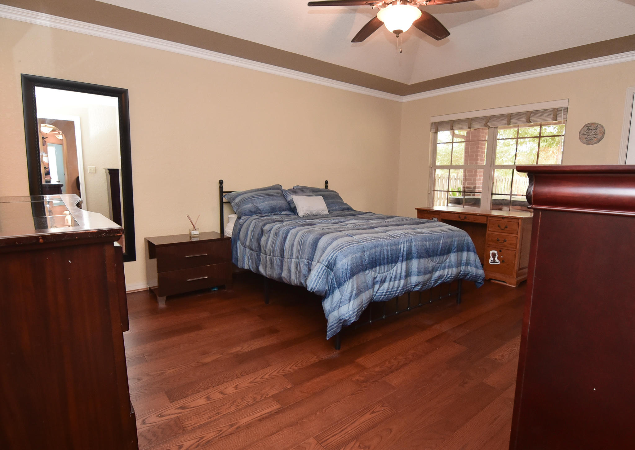 4214 Painter Branch Road Crestview, FL 32539 - Photo 8 of 41 a spacious bedroom with a bed and a chandelier