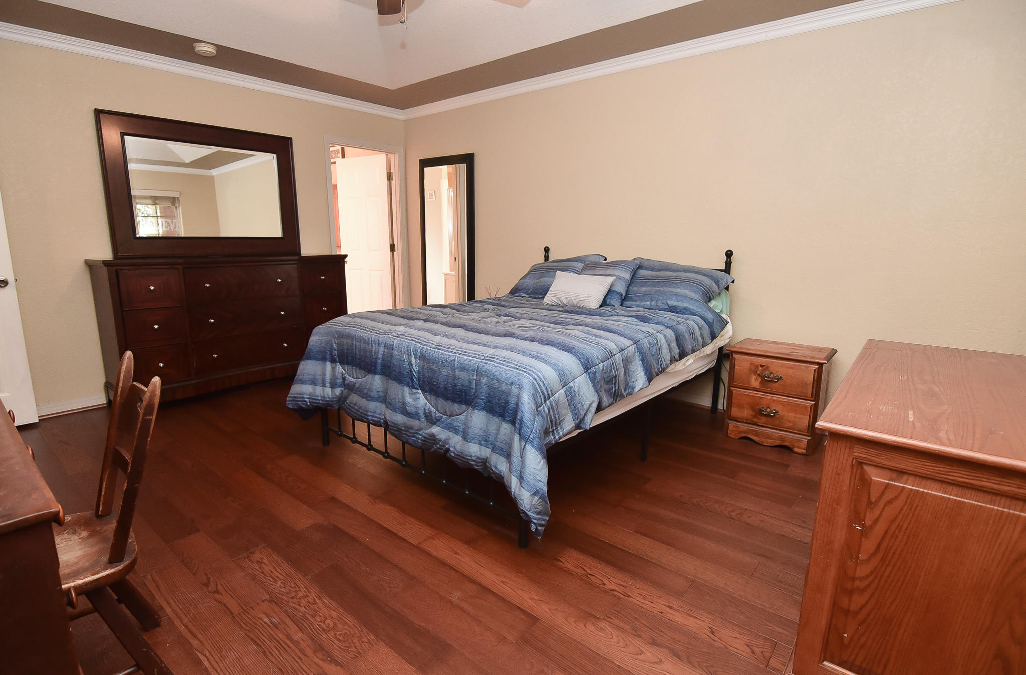 4214 Painter Branch Road Crestview, FL 32539 - Photo 9 of 41 a bedroom with a bed and dresser with mirror