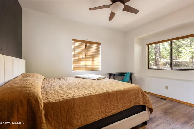 a bed sitting in a bedroom next to a window