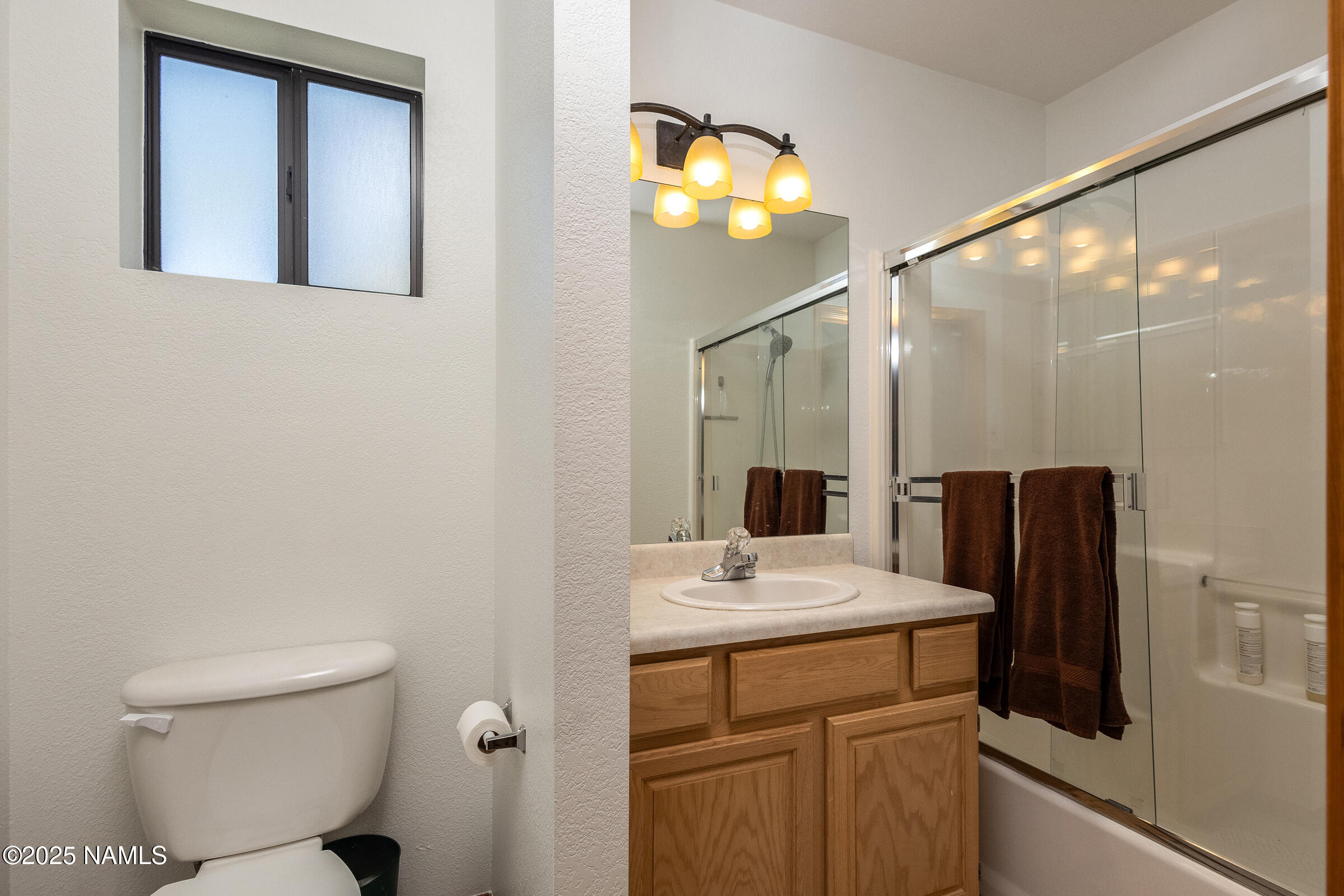 335 Sandia Circle Munds Park, AZ 86017 - Photo 21 of 34 a bathroom with a sink a toilet and a mirror