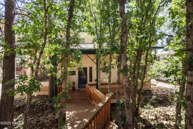 a view of a house with a tree in the background