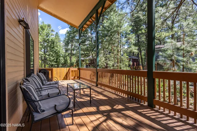 a view of balcony with wooden floor and outdoor seating