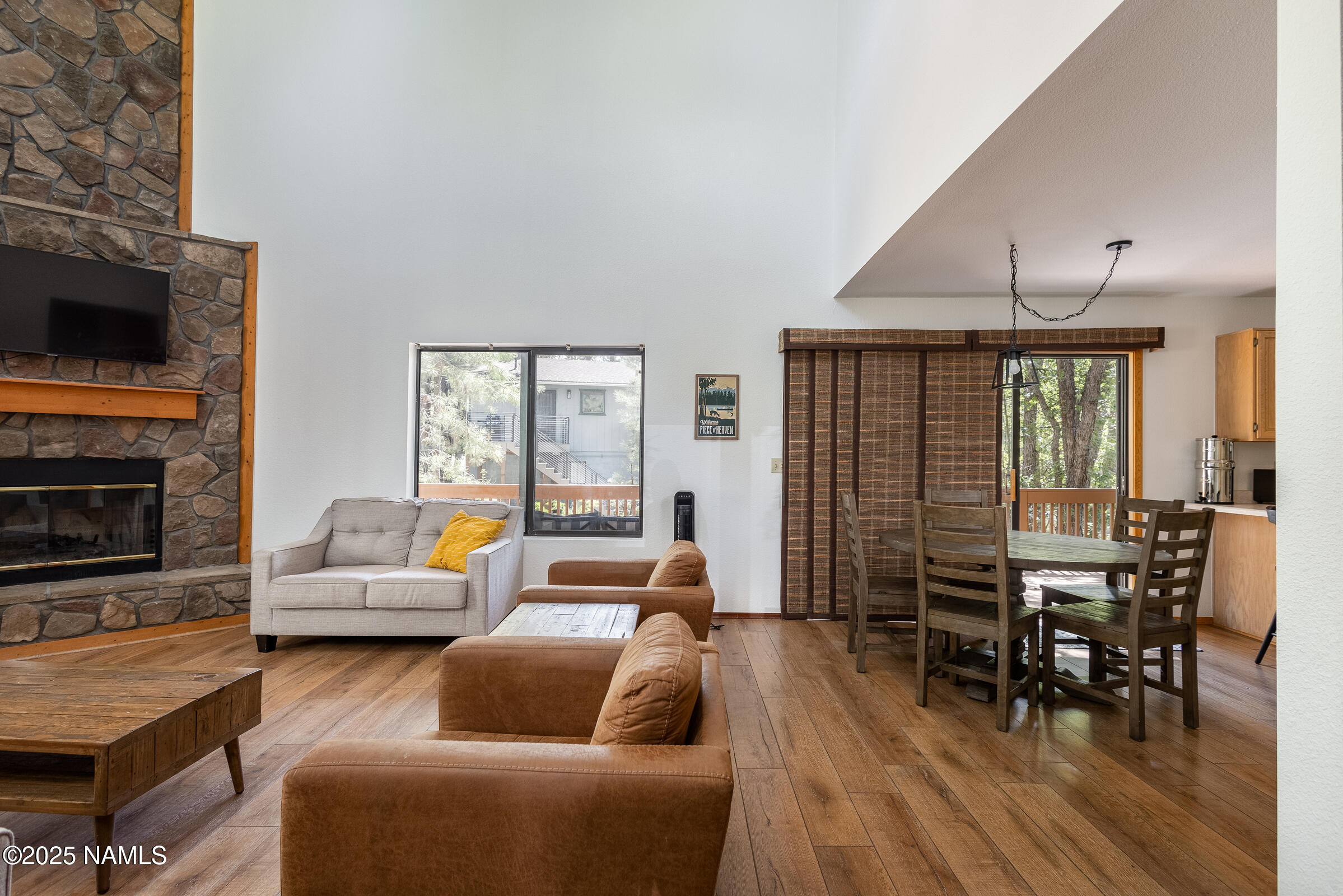 335 Sandia Circle Munds Park, AZ 86017 - Photo 5 of 34 a living room with furniture a flat screen tv and wooden floor