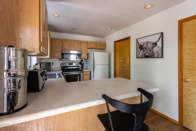 a kitchen with appliances a sink and cabinets