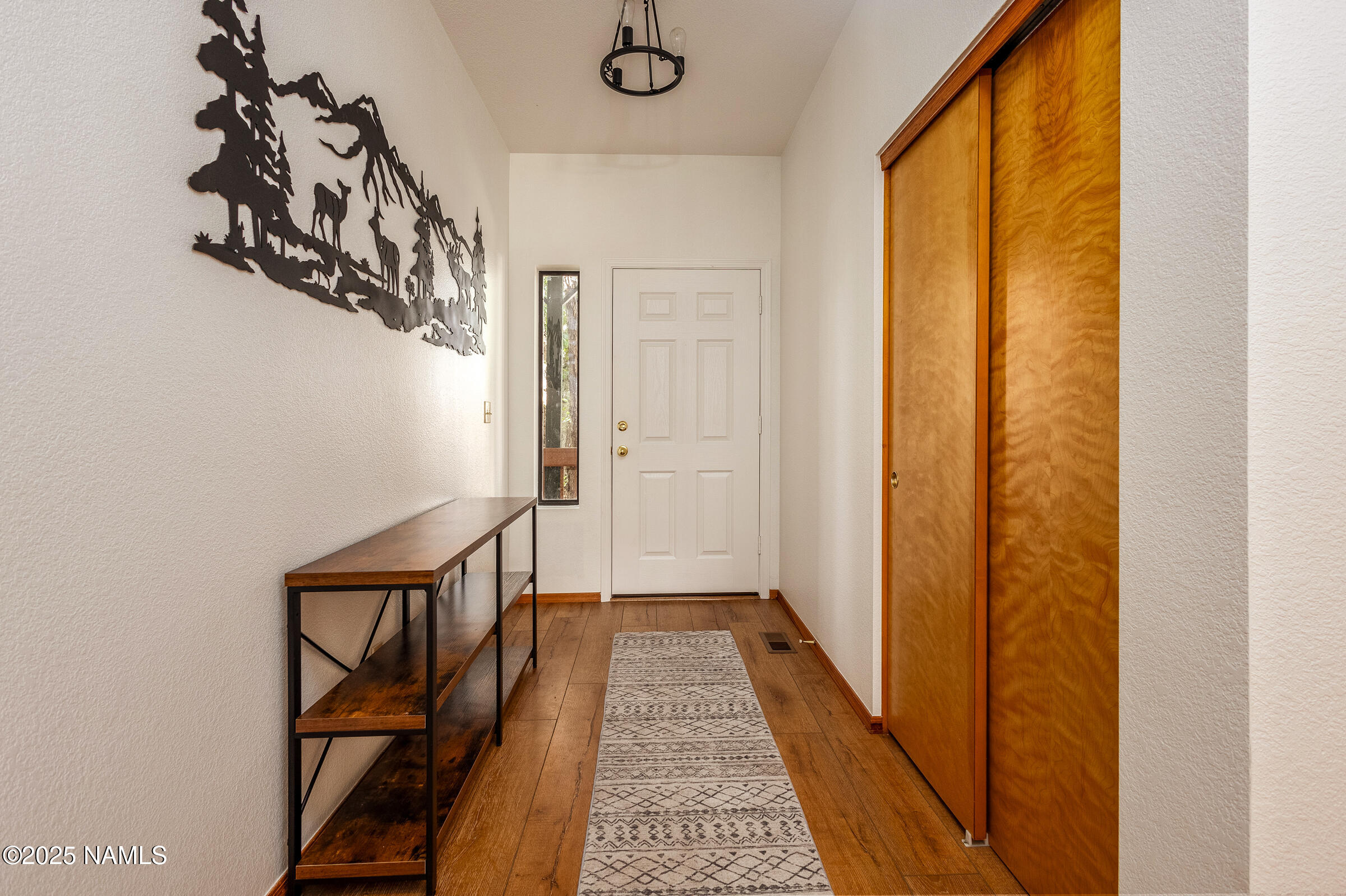 335 Sandia Circle Munds Park, AZ 86017 - Photo 10 of 34 a view of a hallway with wooden floor and staircase