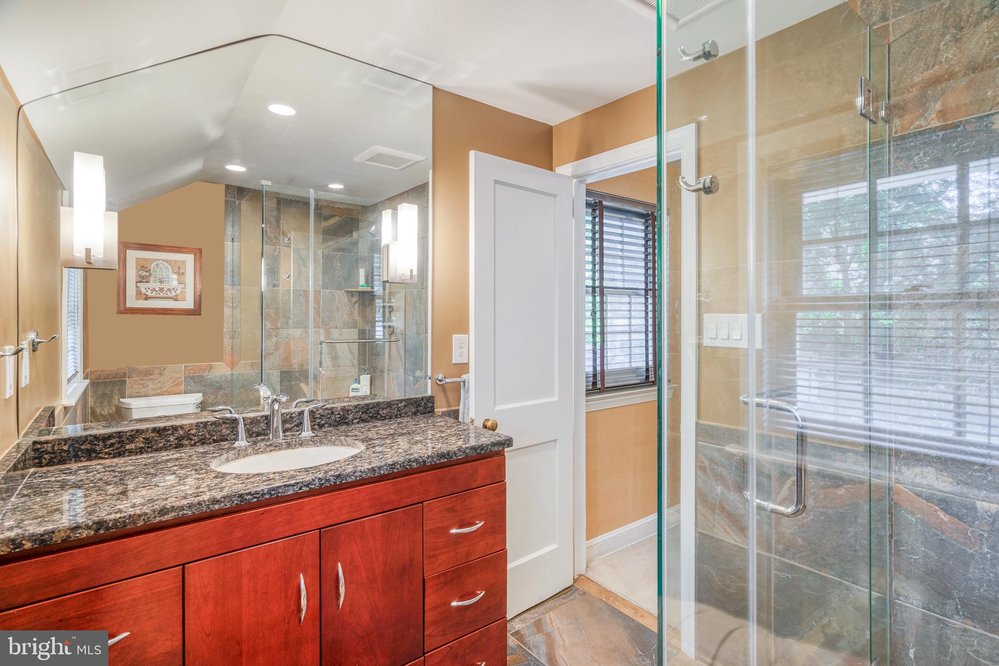 195 Lakeside Road Ardmore, PA 19003 - Photo 22 of 28 a bathroom with a granite countertop sink and a mirror