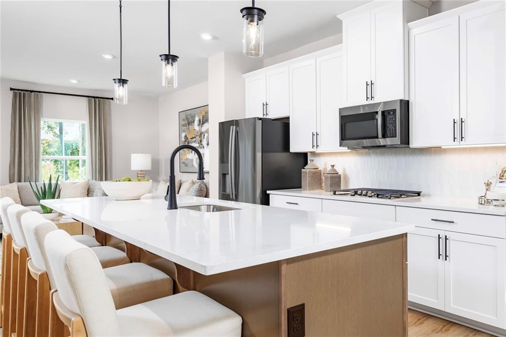 130 Goldenthread Way Coraopolis, PA 15108 - Photo 17 of 27 a kitchen with stainless steel appliances a stove a sink a microwave a refrigerator and white cabinets