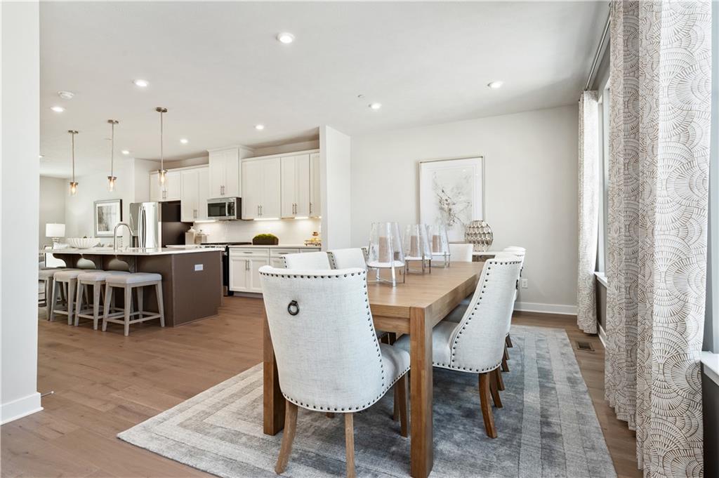 130 Goldenthread Way Coraopolis, PA 15108 - Photo 3 of 27 a dining room with stainless steel appliances kitchen island granite countertop a sink and a refrigerator