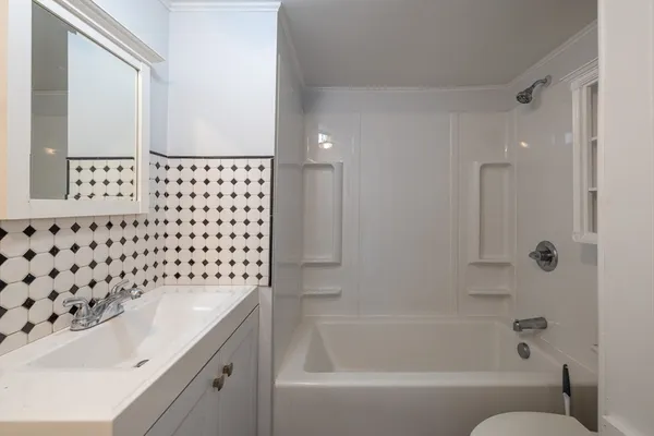 a bathroom with a bathtub and a shower