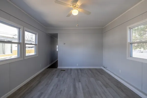 wooden floor in an empty room with a window