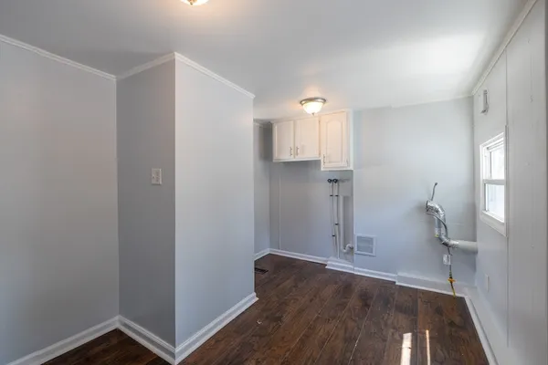 a view of empty room with wooden floor