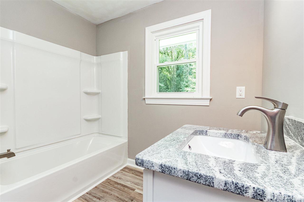 733 St George Road Raleigh, NC 27610 - Photo 22 of 29 a bathroom with a granite countertop sink and a bathtub