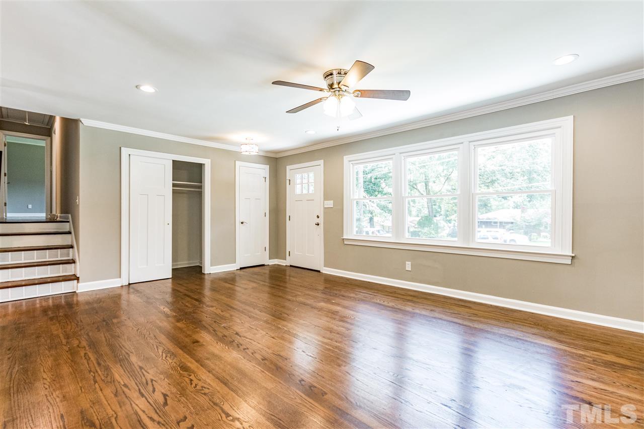 733 St George Road Raleigh, NC 27610 - Photo 8 of 29 an empty room with wooden floor fan and windows