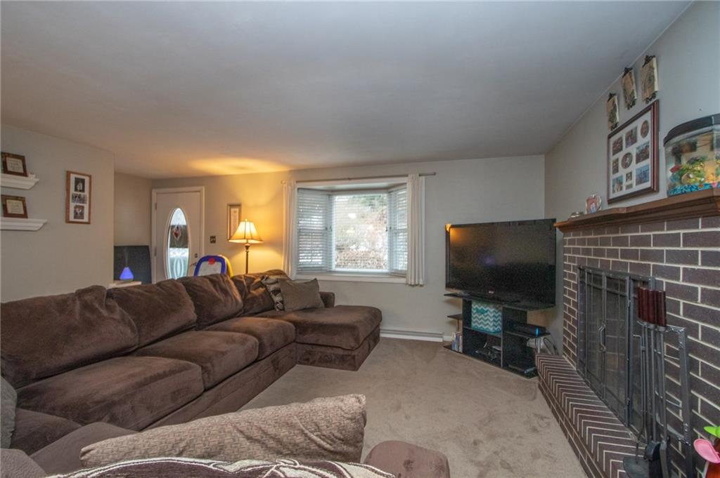 1364 Sharon Road Beaver, PA 15009 - Photo 7 of 18 Large Living Room with decorative fireplace and bay window overlooking front lawn