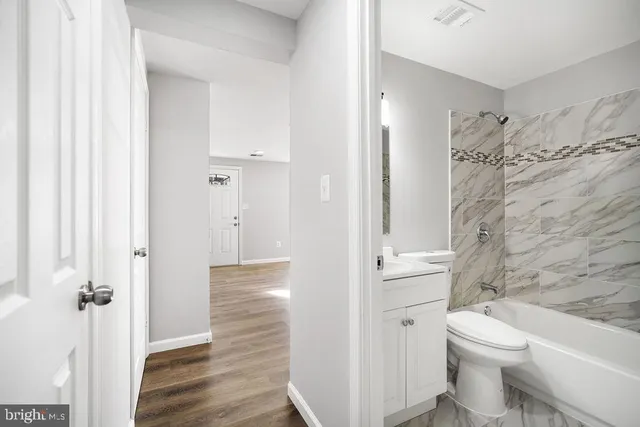 a bathroom with a toilet sink and shower