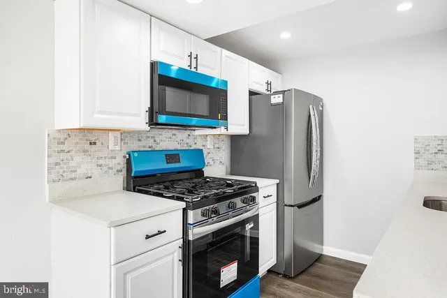 a white toilet sitting next to a bathroom sink