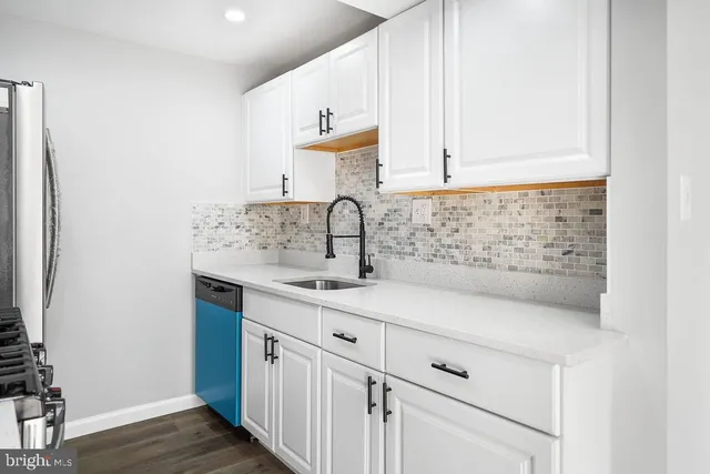 a kitchen with a sink and cabinets