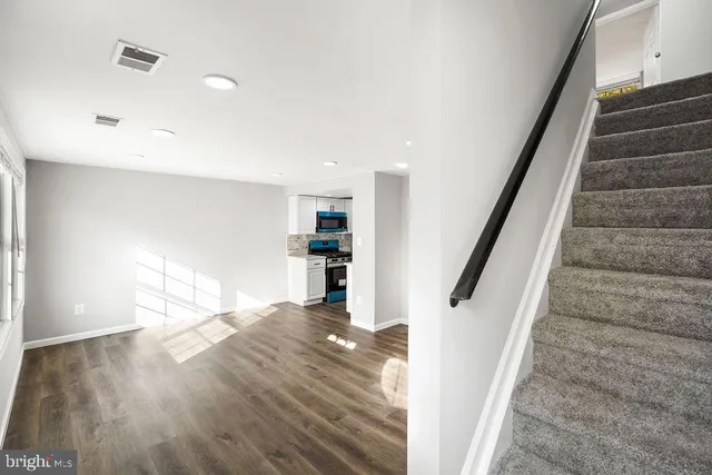 a view of entryway and hall with wooden floor