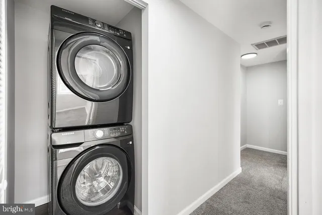 a view of a storage and utility room with washer and dryer