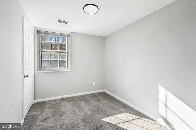 a view of empty room with windows