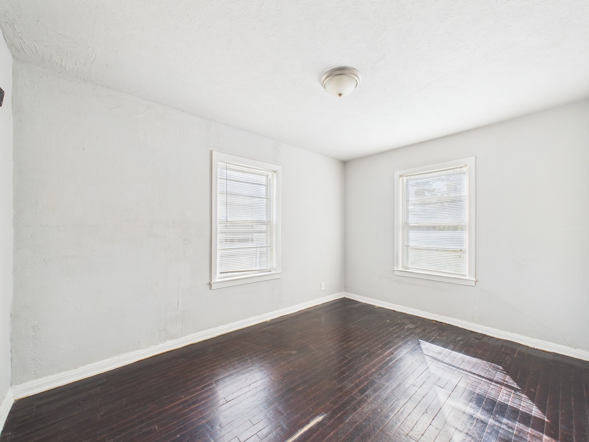 3814 Luca Street Houston, TX 77021 - Photo 14 of 31 an empty room with wooden floor and windows