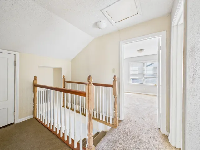 a view of a hallway with entryway door
